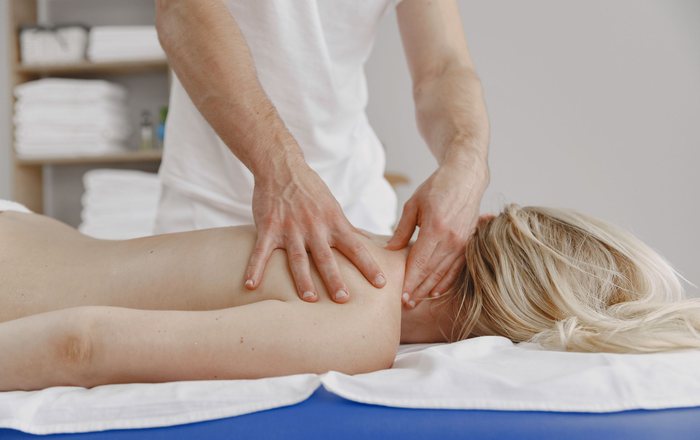 Therapist treating a patient’s neck and upper back