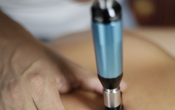 Shockwave therapy applicator being used during a treatment session